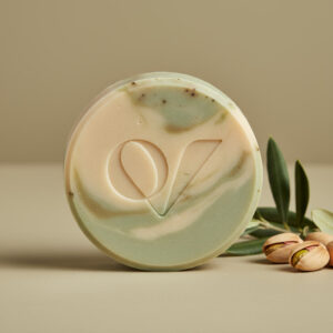 Olive oil soap by Oryvane with soft green-beige tones and smooth, creamy texture on a neutral background.